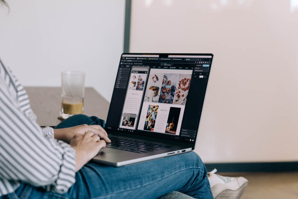Image of woman working on a laptop with images on a website. Image optimization tools.