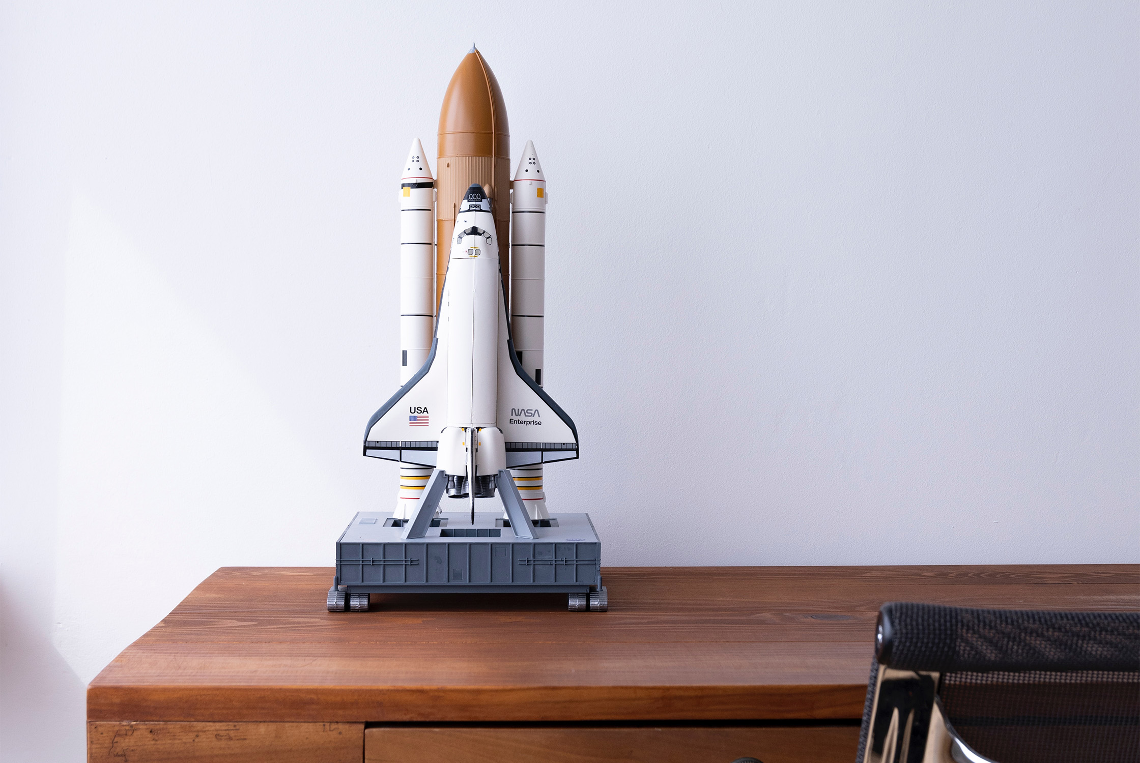 Spaceship figure on desk to represent launching your showit site in 1 day