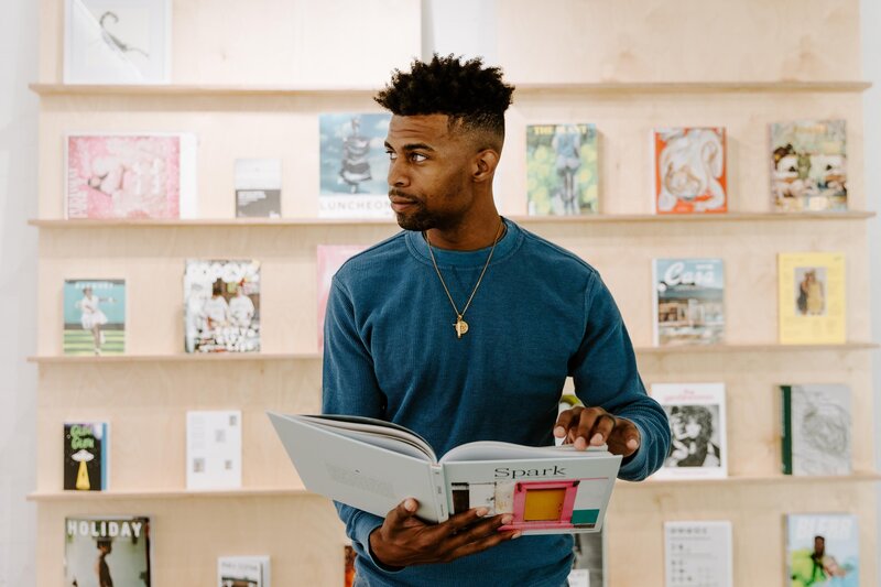 Man looking while holding Showit Spark Book